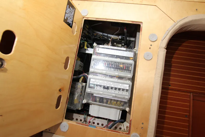 Slide: The Image of Electrical panel inside a 2001 Nautor Swan 44MKII yacht, showcasing circuit breakers and wiring. - 46
