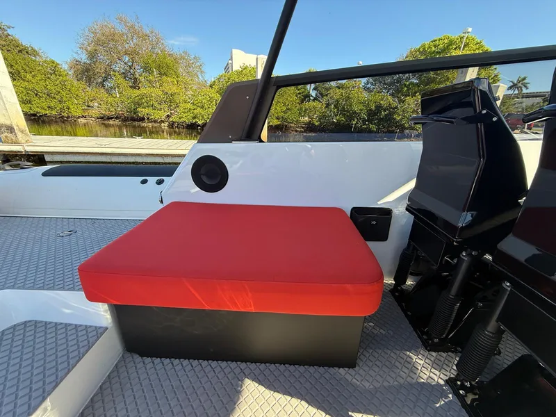 Slide: The Image of 2024 Goldfish 46 Open boat with red seat cushion, sleek design, and outdoor setting. - 13