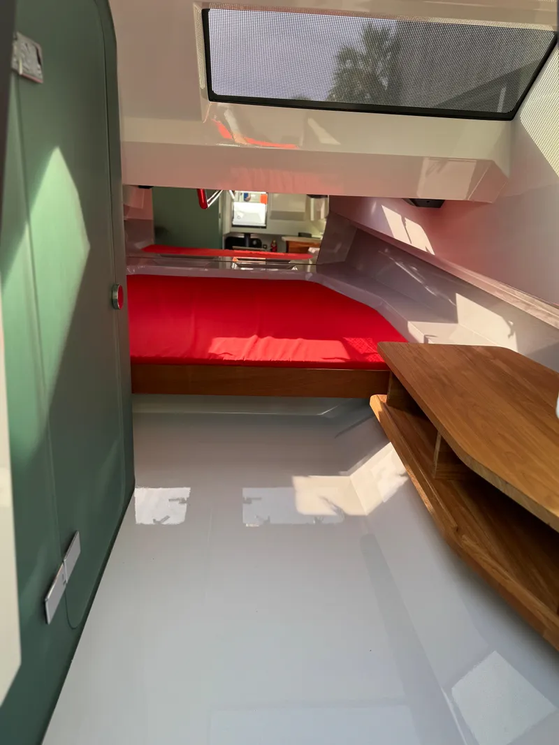 Slide: The Image of Interior of 2024 Goldfish 46 Open boat with red bedding and wooden furnishings. - 17