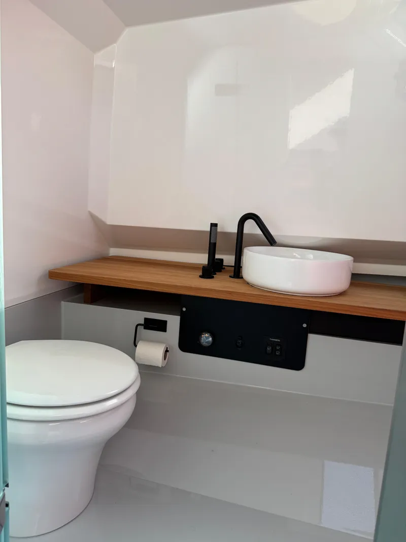 Slide: The Image of Modern bathroom in 2024 Goldfish 46 Open boat with sleek fixtures and wooden countertop. - 18