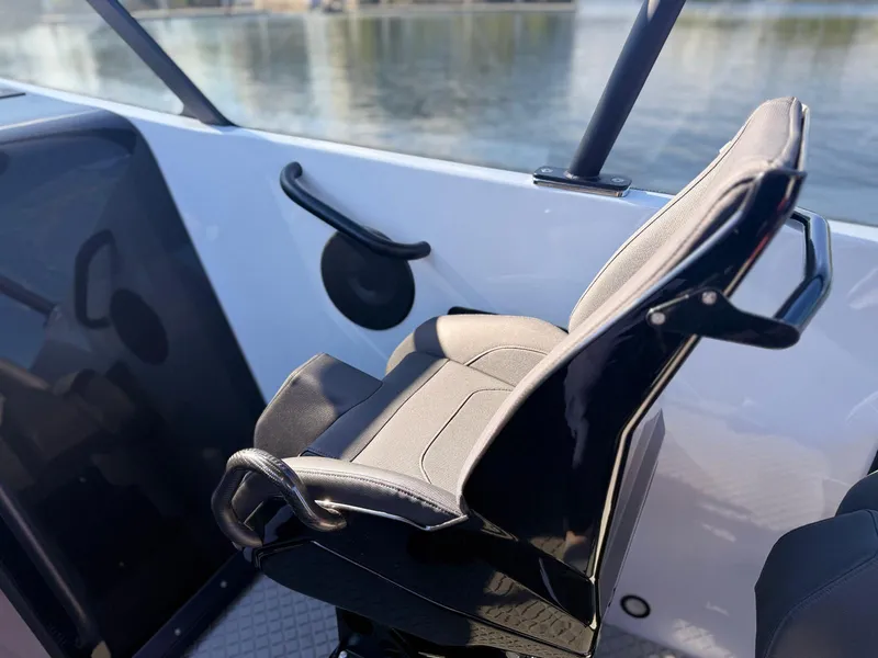 Slide: The Image of 2024 Goldfish 46 Open boat seat with sleek design and waterfront view. - 22