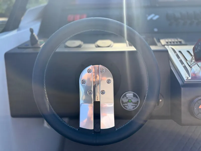 Slide: The Image of Steering wheel of 2024 Goldfish 46 Open boat, featuring modern controls and sleek design. - 24