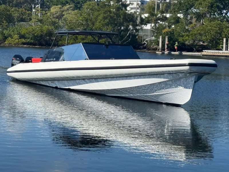 Slide: The Image of 2024 Goldfish 46 Open boat on calm water, sleek design, modern features. - 7