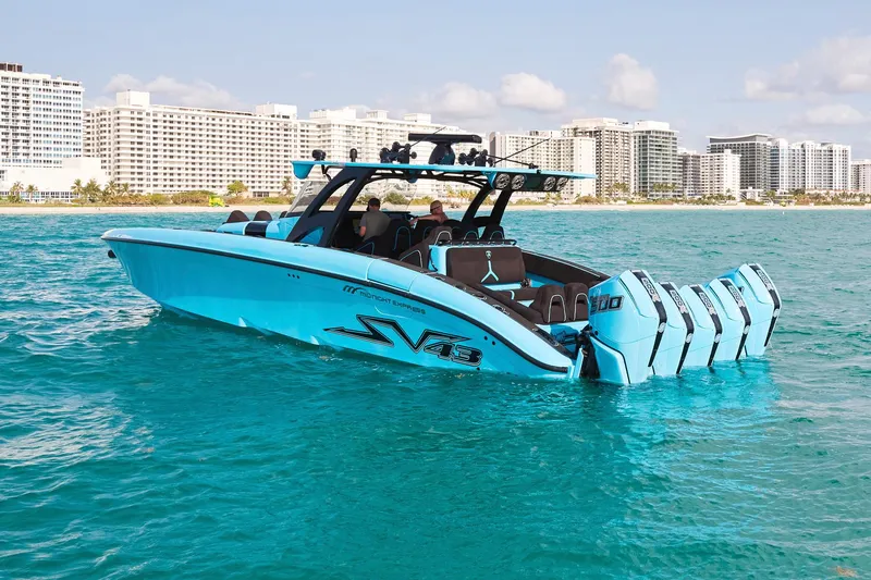 Slide: The Image of 2024 Midnight Express 43' Solstice boat on turquoise water, city skyline in background. - 11