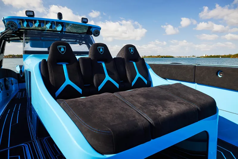 Slide: The Image of 2024 Midnight Express 43' Solstice boat interior with sleek black and blue seating. - 13