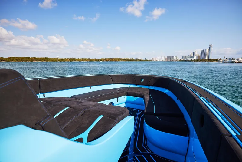 Slide: The Image of 2024 Midnight Express 43' Solstice luxury boat on serene water with city skyline. - 15