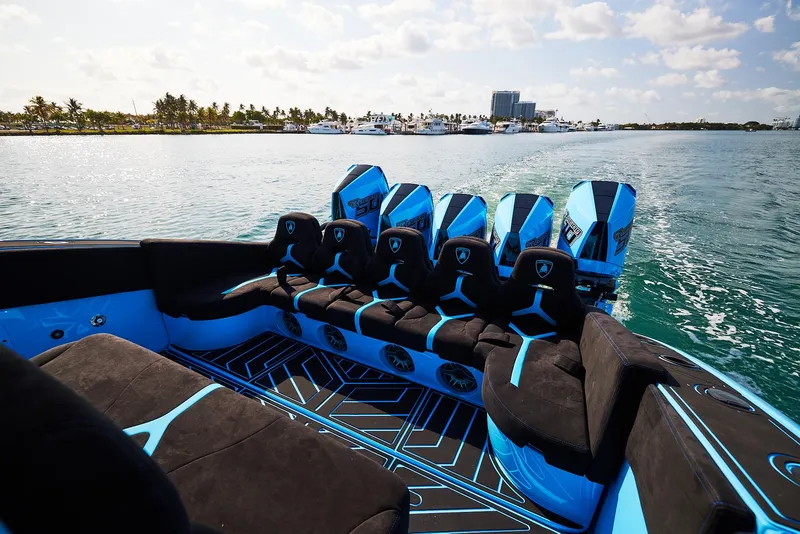 Slide: The Image of 2024 Midnight Express 43' Solstice luxury boat with sleek blue and black seating. - 25