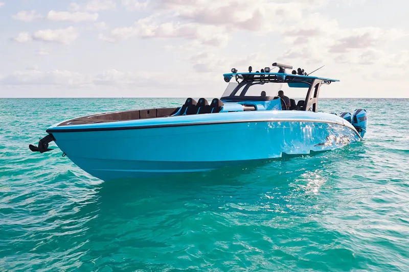 Slide: The Image of 2024 Midnight Express 43' Solstice boat on turquoise water under a partly cloudy sky. - 9