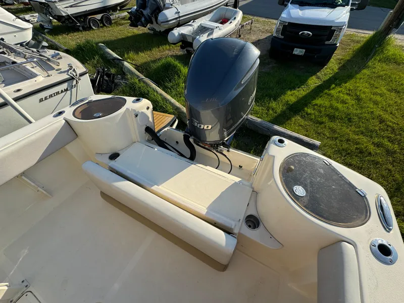 Slide: The Image of 2014 Scout 245 XSF boat with Yamaha outboard motor, docked outdoors. - 11