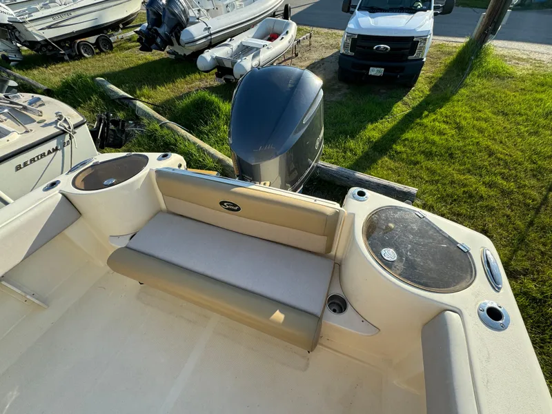 Slide: The Image of 2014 Scout 245 XSF boat interior with seating and outboard motor. - 12