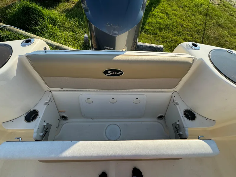 Slide: The Image of 2014 Scout 245 XSF boat interior with seating and storage compartments. - 13