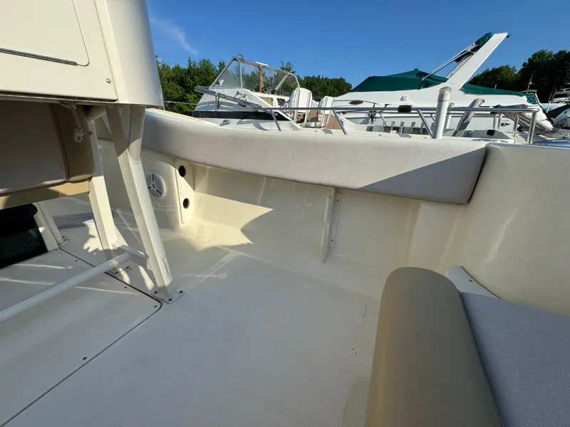 Slide: The Image of 2014 Scout 245 XSF boat interior with seating and clear sky background. - 16