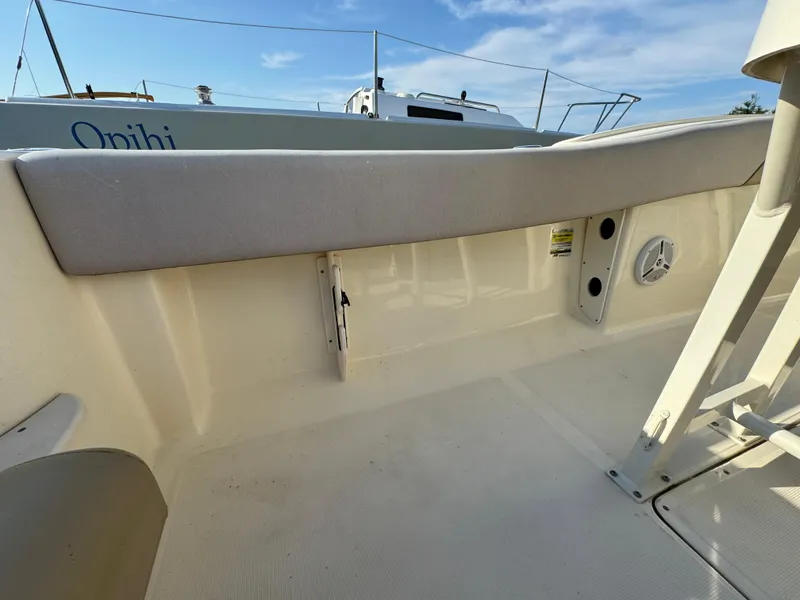 Slide: The Image of 2014 Scout 245 XSF boat interior with cushioned seating and speaker. - 17