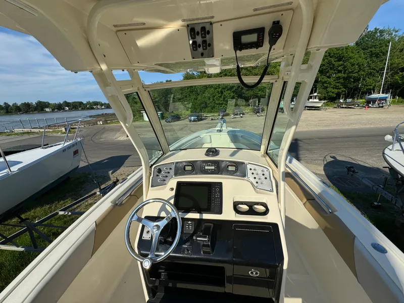 Slide: The Image of 2014 Scout 245 XSF boat cockpit with steering wheel and control panel. - 20