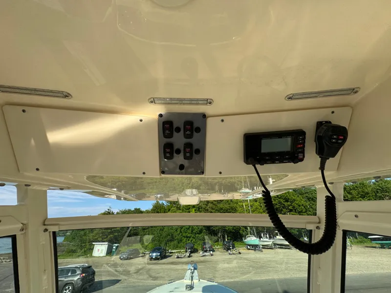 Slide: The Image of 2014 Scout 245 XSF boat interior with control panel and radio. - 27