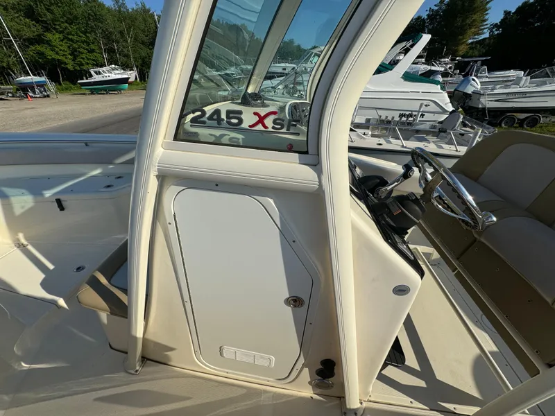 Slide: The Image of 2014 Scout 245 XSF boat interior with steering wheel and seating area. - 28