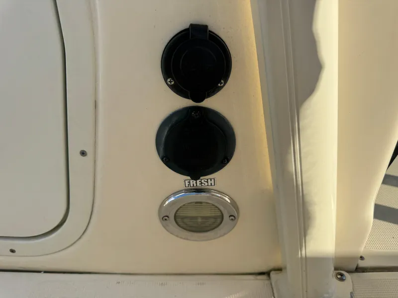 Slide: The Image of 2014 Scout 245 XSF boat panel with fresh water outlet and light. - 29