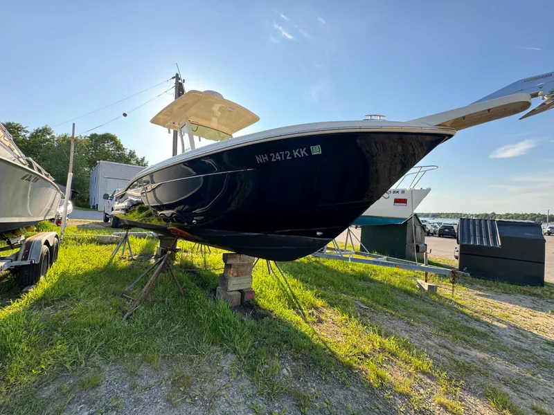 Slide: The Image of 2014 Scout 245 XSF boat on dry land, sunny day, side view. - 3