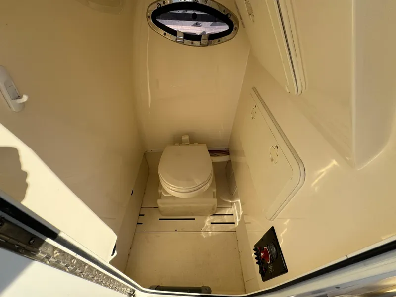 Slide: The Image of 2014 Scout 245 XSF boat interior with compact marine toilet. - 30