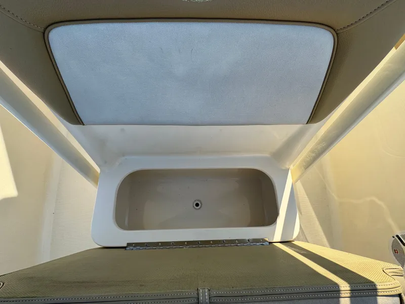 Slide: The Image of 2014 Scout 245 XSF boat storage compartment, open lid view. - 33
