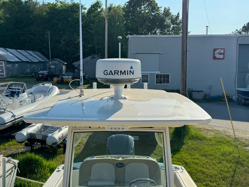 Slide: The Image of 2014 Scout 245 XSF boat with Garmin radar, docked near other vessels. - 34