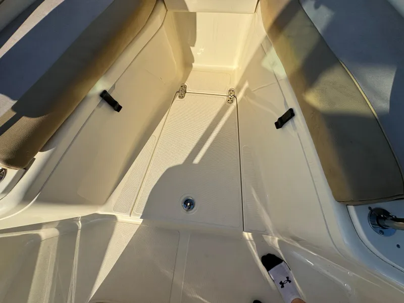 Slide: The Image of Interior view of a 2014 Scout 245 XSF boat with seating and storage. - 39