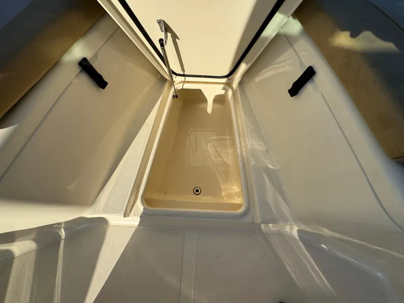 Slide: The Image of 2014 Scout 245 XSF boat storage compartment with open hatch. - 41