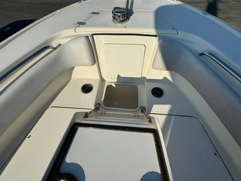 Slide: The Image of 2014 Scout 245 XSF boat interior with storage compartments and seating area. - 42