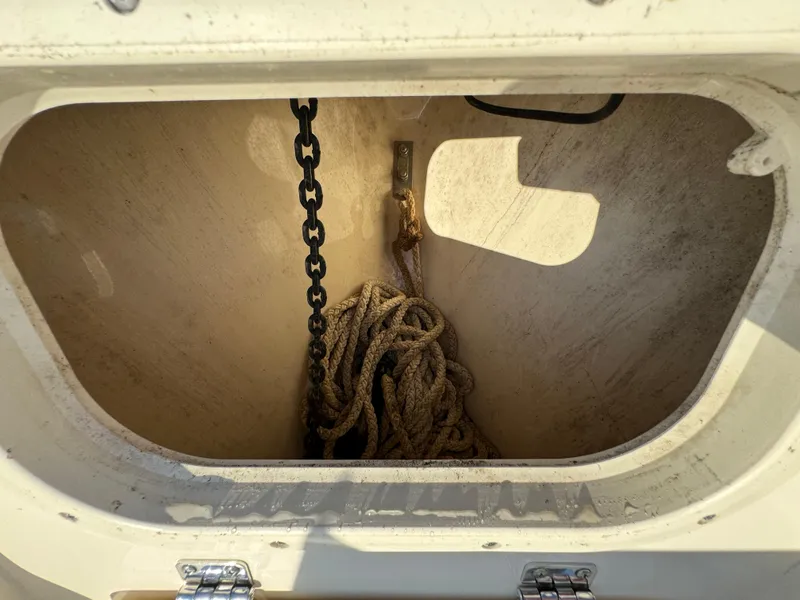 Slide: The Image of Anchor storage compartment on 2014 Scout 245 XSF boat with chain and rope. - 44