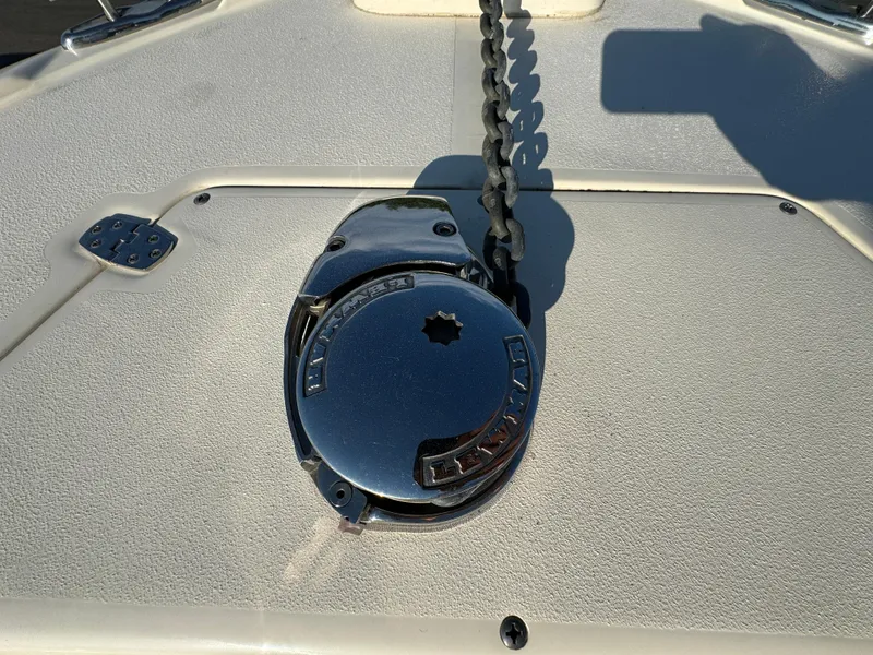 Slide: The Image of 2014 Scout 245 XSF boat anchor winch on deck in sunlight. - 46