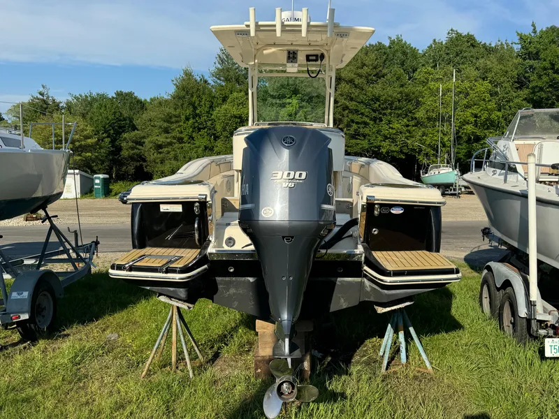 Slide: The Image of 2014 Scout 245 XSF boat with Yamaha 300 V6 engine, parked on grass. - 8