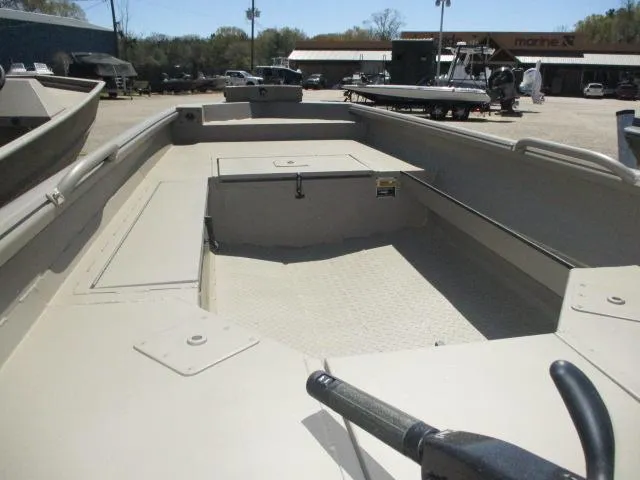 Slide: The Image of 2025 Reaper Boats 653-1236 model, beige interior, parked outdoors at a dealership. - 9