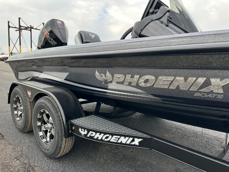 Slide: The Image of 2025 Phoenix 721 ZXL boat, sleek design, dual axle trailer, outdoor setting. - 15