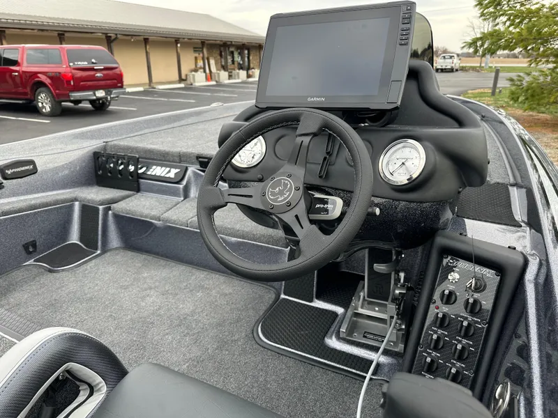 Slide: The Image of 2025 Phoenix 721 ZXL boat cockpit with steering wheel and control panel. - 17