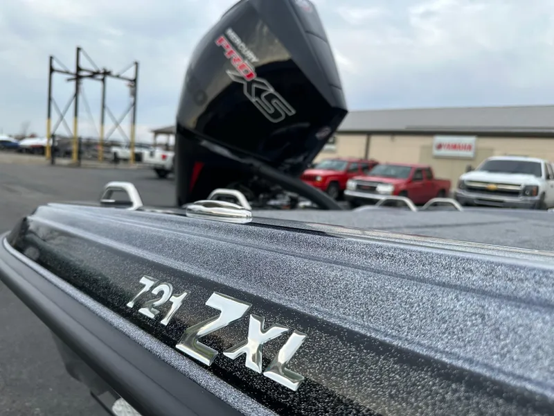 Slide: The Image of 2025 Phoenix 721 ZXL boat with powerful engine, parked outdoors. - 18