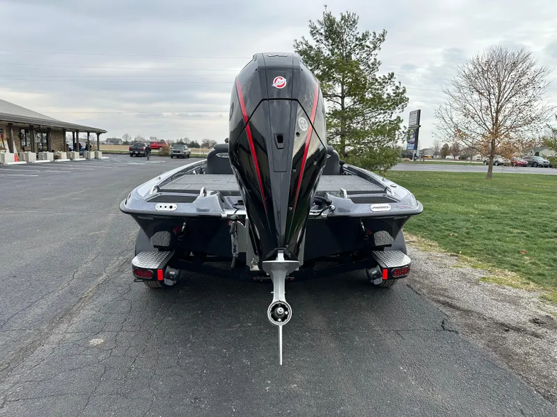 Slide: The Image of 2025 Phoenix 721 ZXL boat with powerful outboard motor, parked on asphalt near trees. - 7