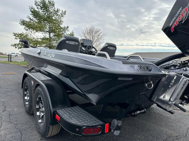 Slide: The Image of 2025 Phoenix 721 ZXL boat on trailer, parked outdoors, overcast sky. - 8