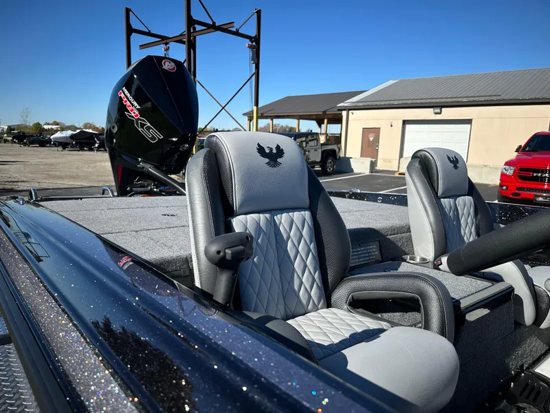 Slide: The Image of 2025 Phoenix 21 XE boat interior with plush seating and powerful engine. - 16