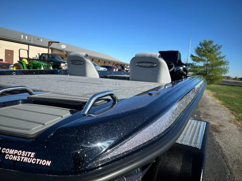 Slide: The Image of 2025 Phoenix 21 XE boat with composite construction, parked outdoors on a sunny day. - 18