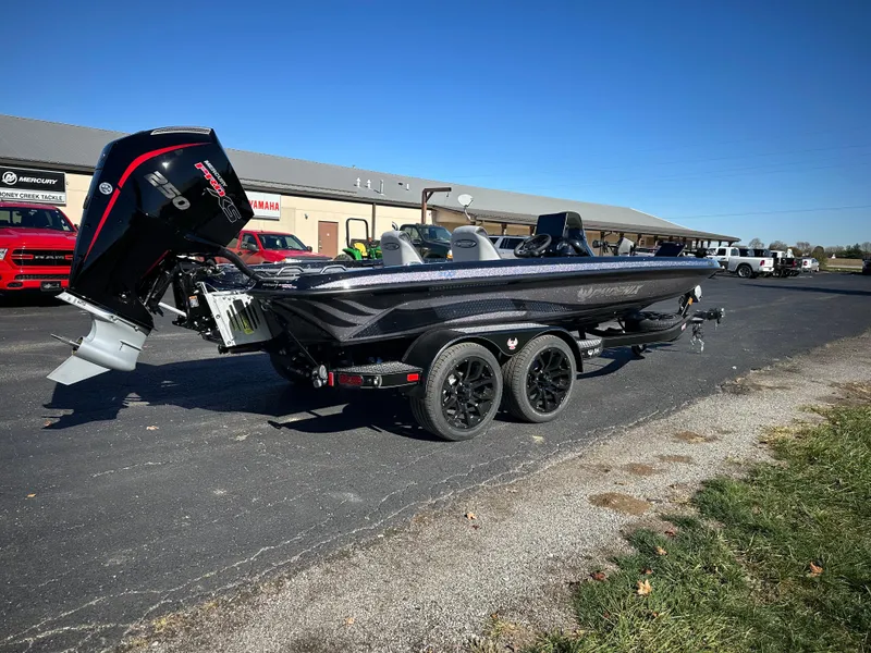 Slide: The Image of 2025 Phoenix 21 XE boat with trailer, parked outdoors on a sunny day. - 6
