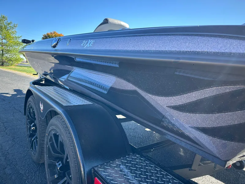 Slide: The Image of 2025 Phoenix 21 XE boat on trailer, sleek design, sunny day. - 9
