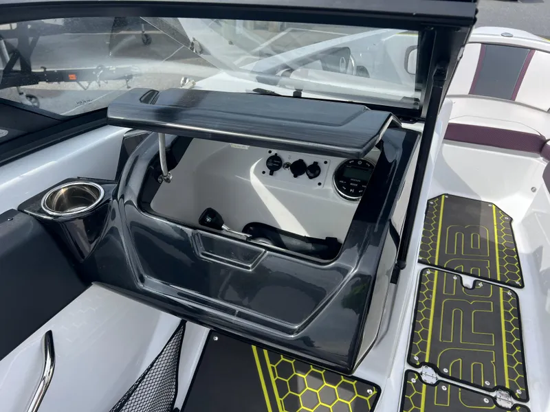 Slide: The Image of 2020 Scarab 215ID boat interior with dashboard and storage compartment. - 10