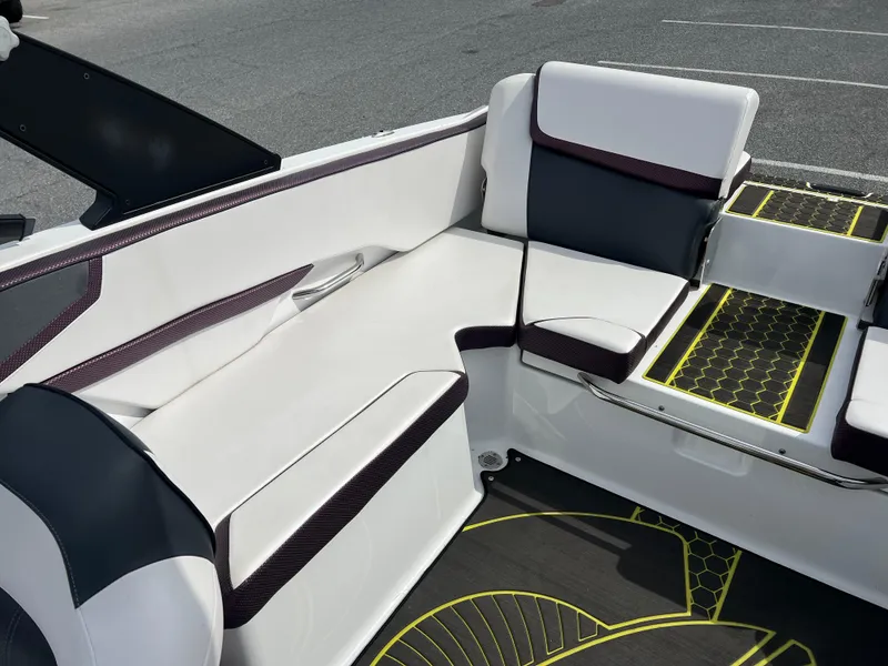 Slide: The Image of 2020 Scarab 215ID boat interior with white and black seating, yellow accents. - 14