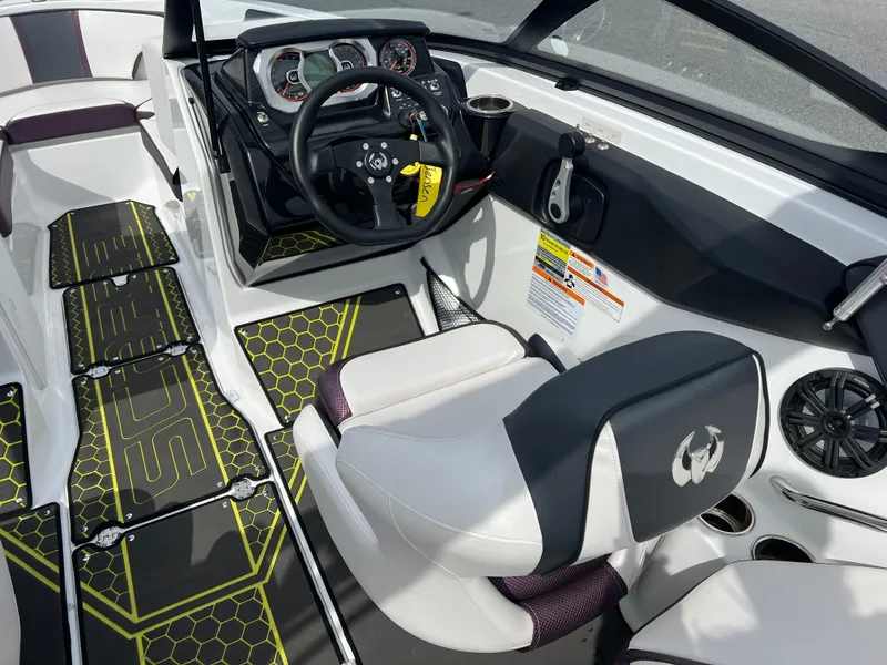 Slide: The Image of 2020 Scarab 215ID boat interior with modern dashboard and seating. - 15