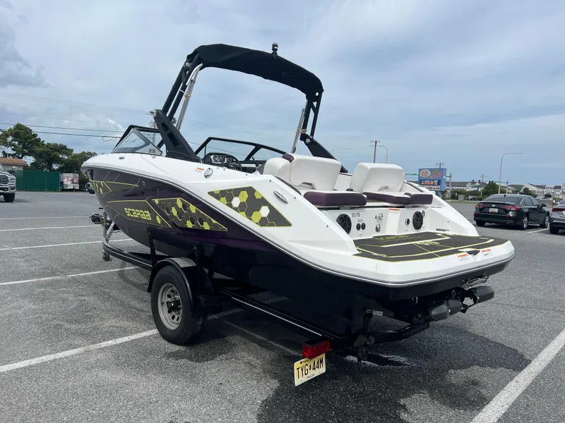 Slide: The Image of 2020 Scarab 215ID boat on trailer in parking lot. - 16