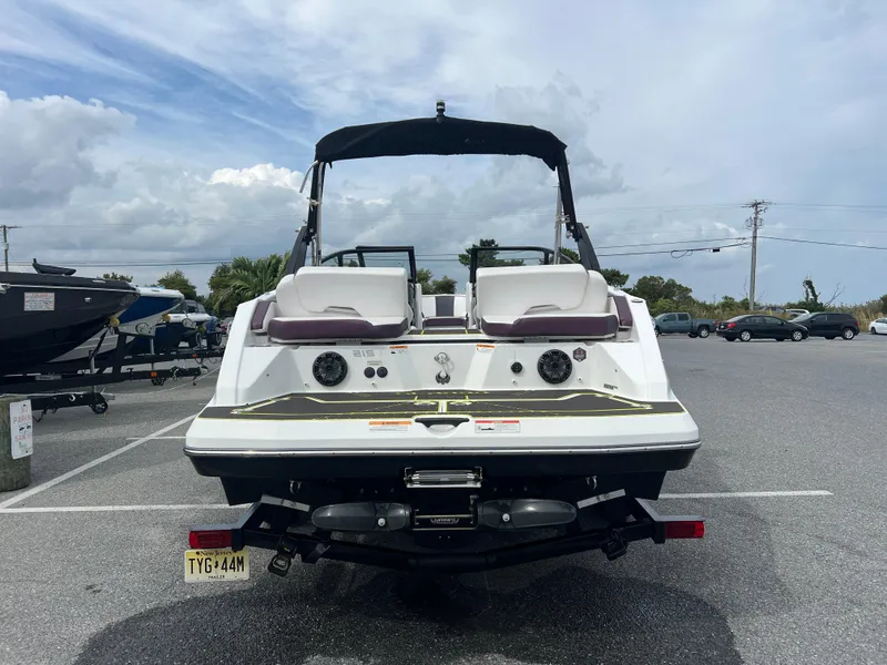 Slide: The Image of 2020 Scarab 215ID boat on trailer in parking lot, rear view. - 17