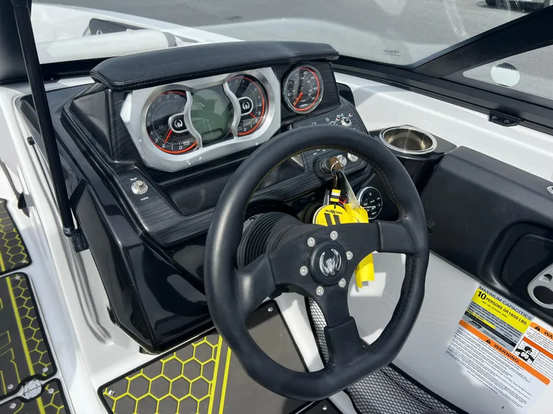 Slide: The Image of 2020 Scarab 215ID boat dashboard with steering wheel and instrument panel. - 3