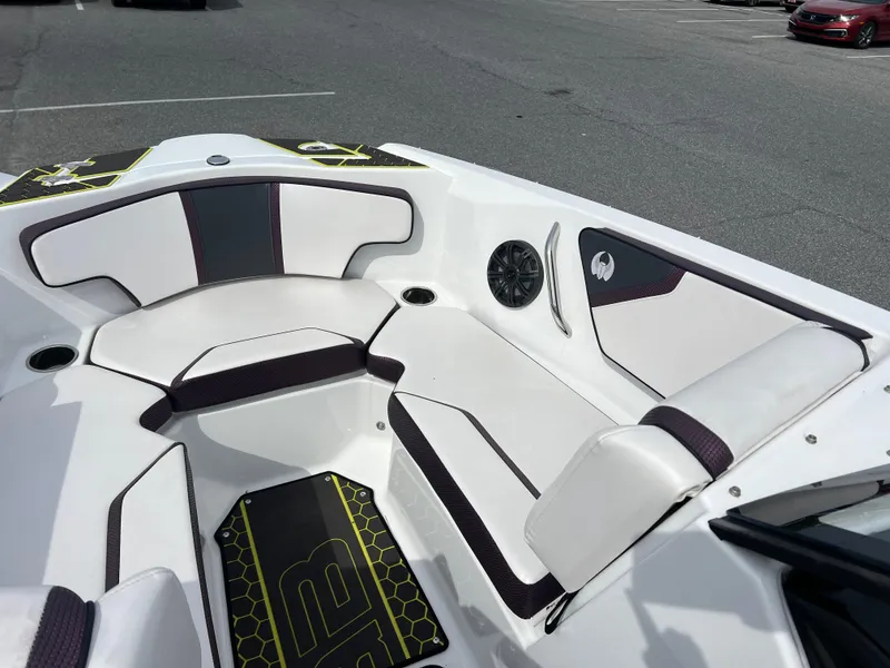 Slide: The Image of 2020 Scarab 215ID boat interior with white and black seating, speaker, and stylish design. - 7