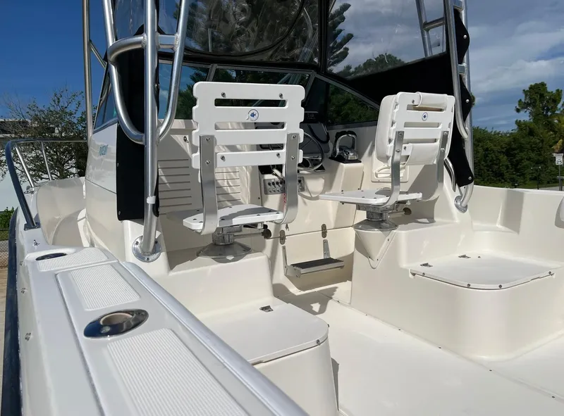 Slide: The Image of 1995 Pursuit 2470 boat interior with dual swivel seats and control panel. - 14