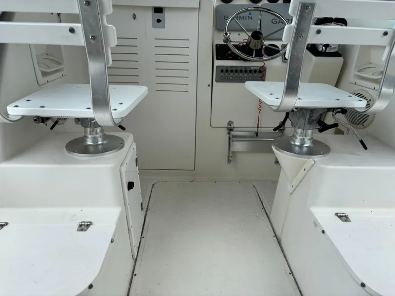 Slide: The Image of Interior of a 1995 Pursuit 2470 boat with dual seating and steering console. - 16